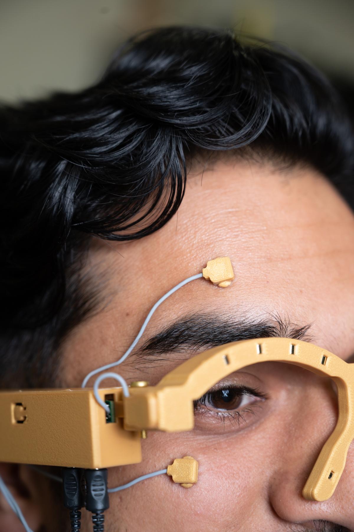 A researcher wearing neurons on their face