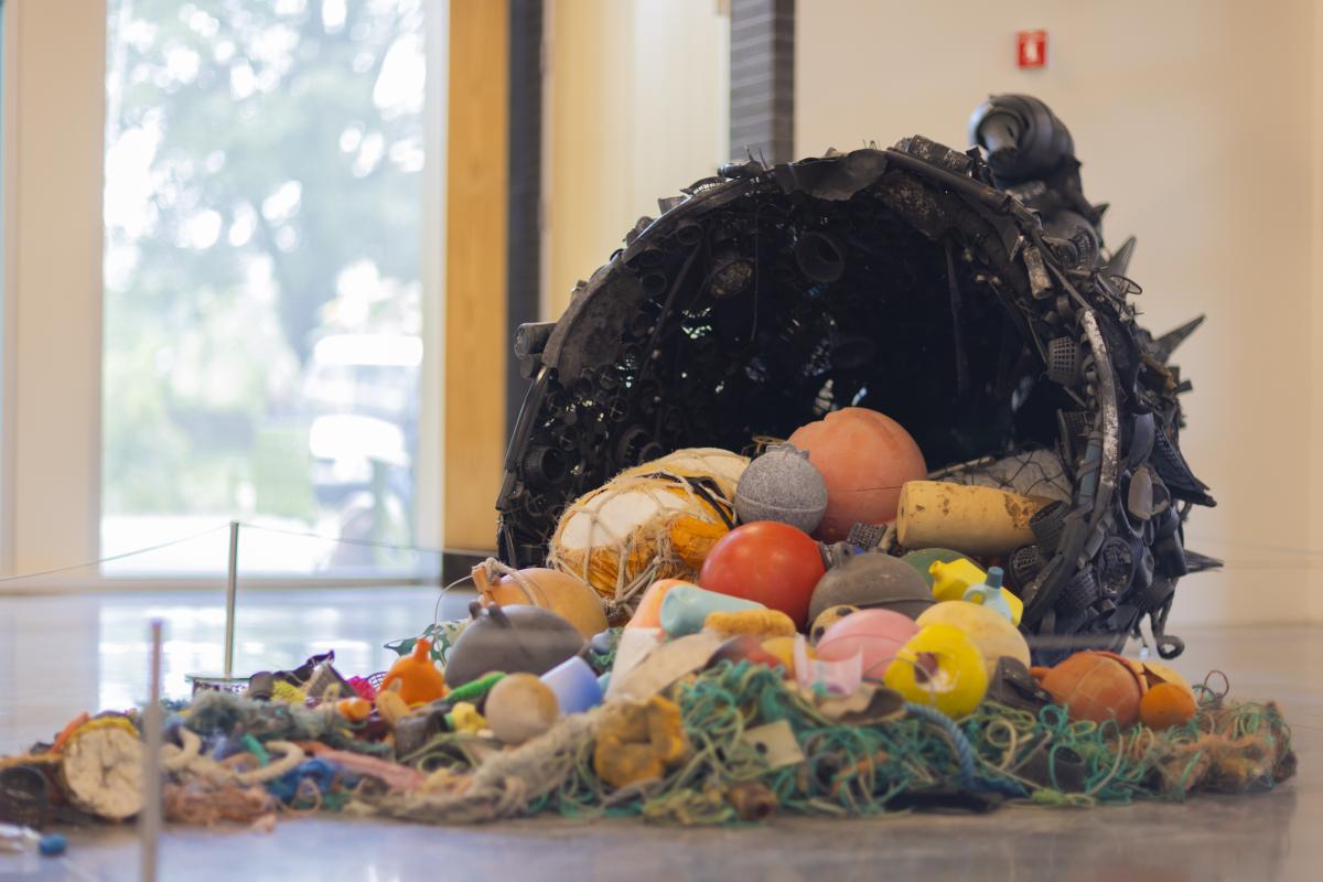 Trash collected into an art installation piece, as seen from the side.